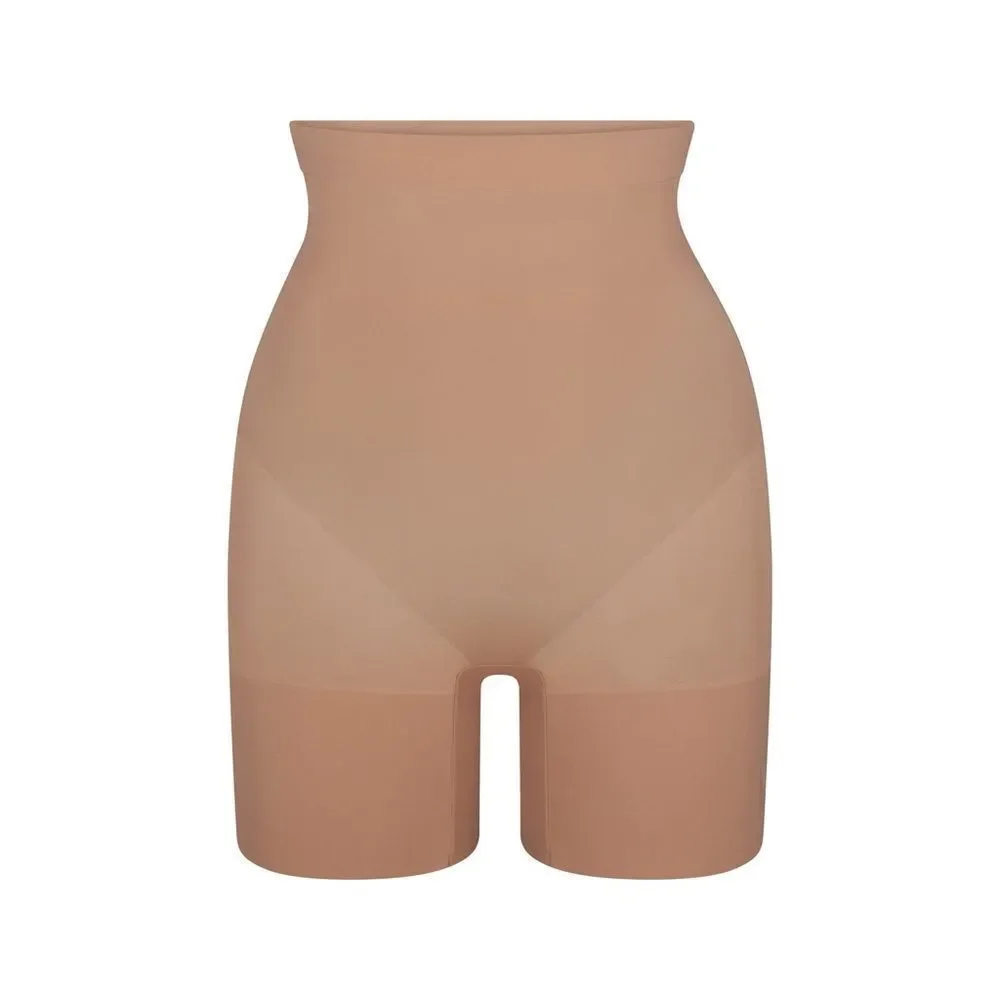 SKIMS high-waisted mid thigh short in color sienna in the size Small